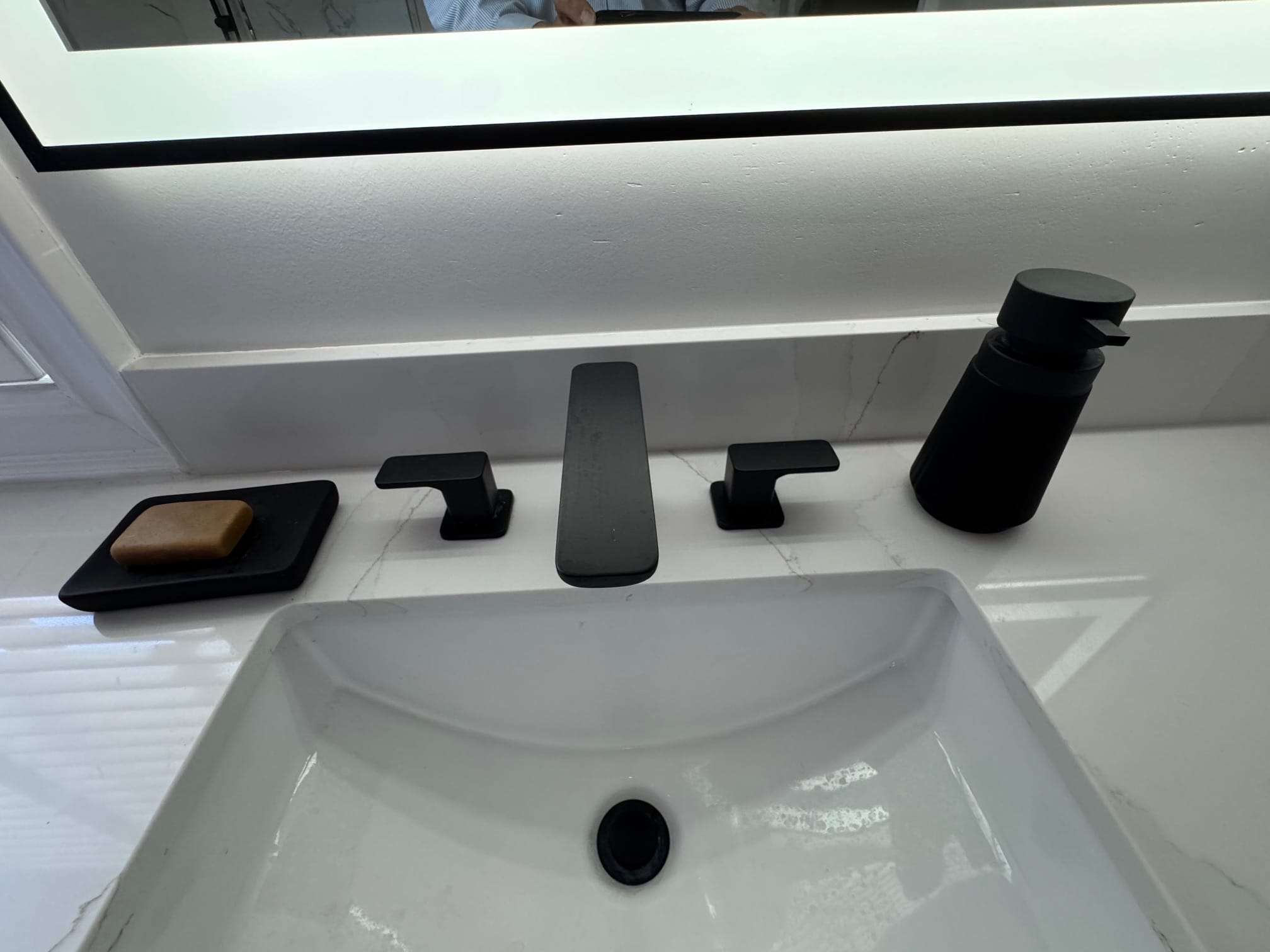 Undermount sink with a black widespread faucet